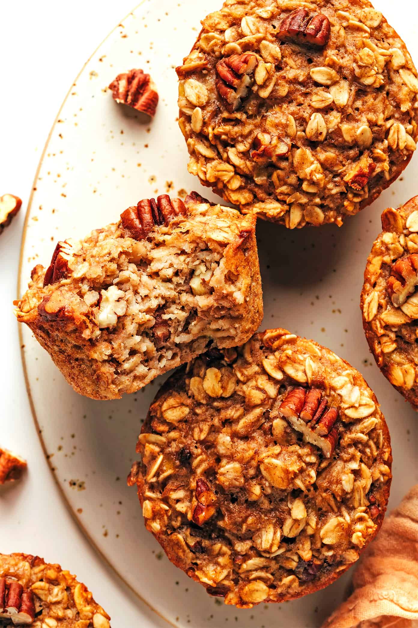 This banana baked oatmeal cups recipe is easy to make, naturally gluten-free, and perfect for healthy grab-and-go breakfast and snacks. Feel free to add in nuts, chocolate chips, raisins or coconut if you'd like too. And these oat cups freeze well if you'd like to do some meal prep for make ahead breakfasts. | gimmesomeoven.com Banana Baked Oatmeal Cups with Pecans