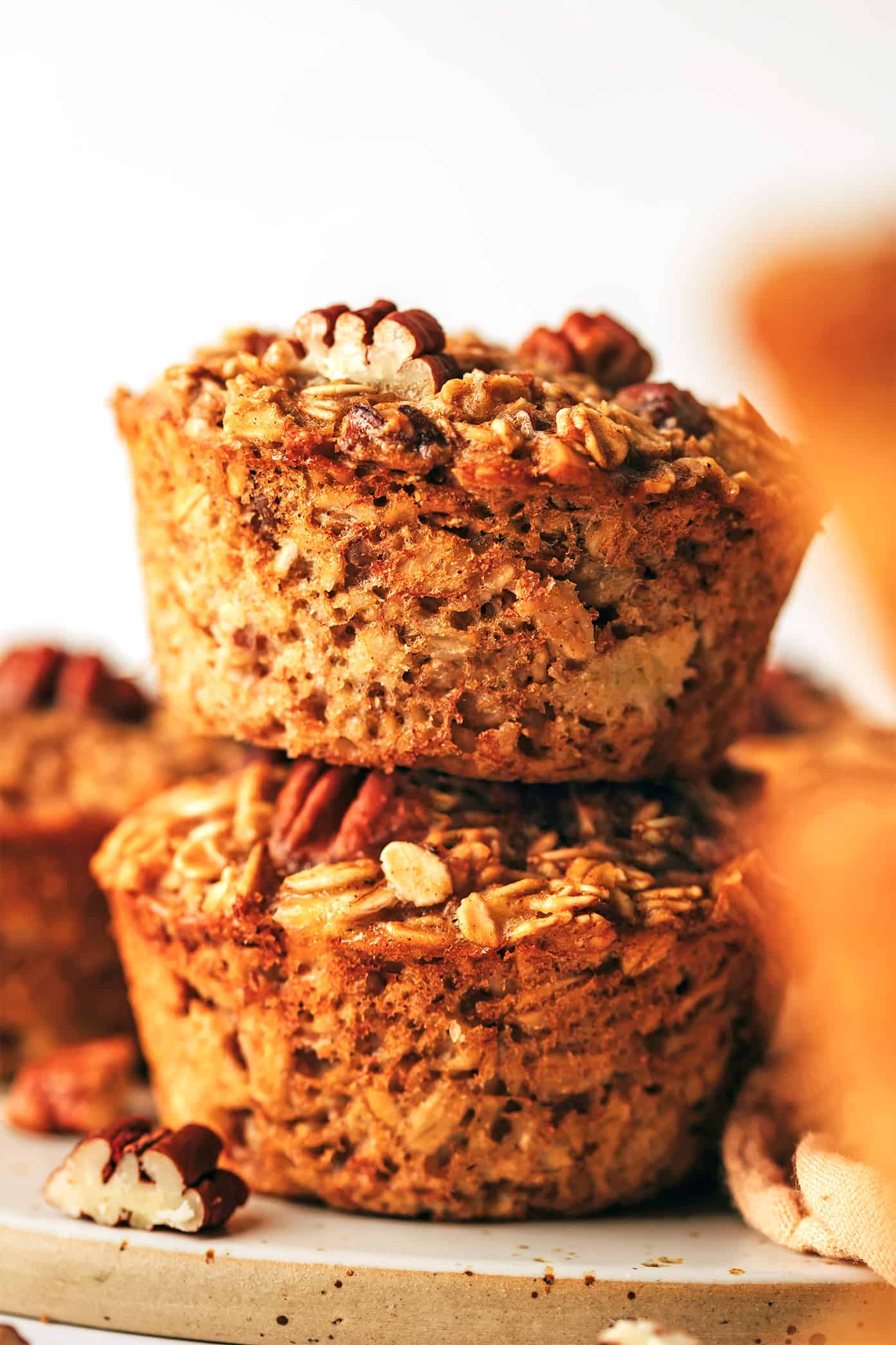 This banana baked oatmeal cups recipe is easy to make, naturally gluten-free, and perfect for healthy grab-and-go breakfast and snacks. Feel free to add in nuts, chocolate chips, raisins or coconut if you'd like too. And these oat cups freeze well if you'd like to do some meal prep for make ahead breakfasts. | gimmesomeoven.com Banana Baked Oatmeal Cups Stacked