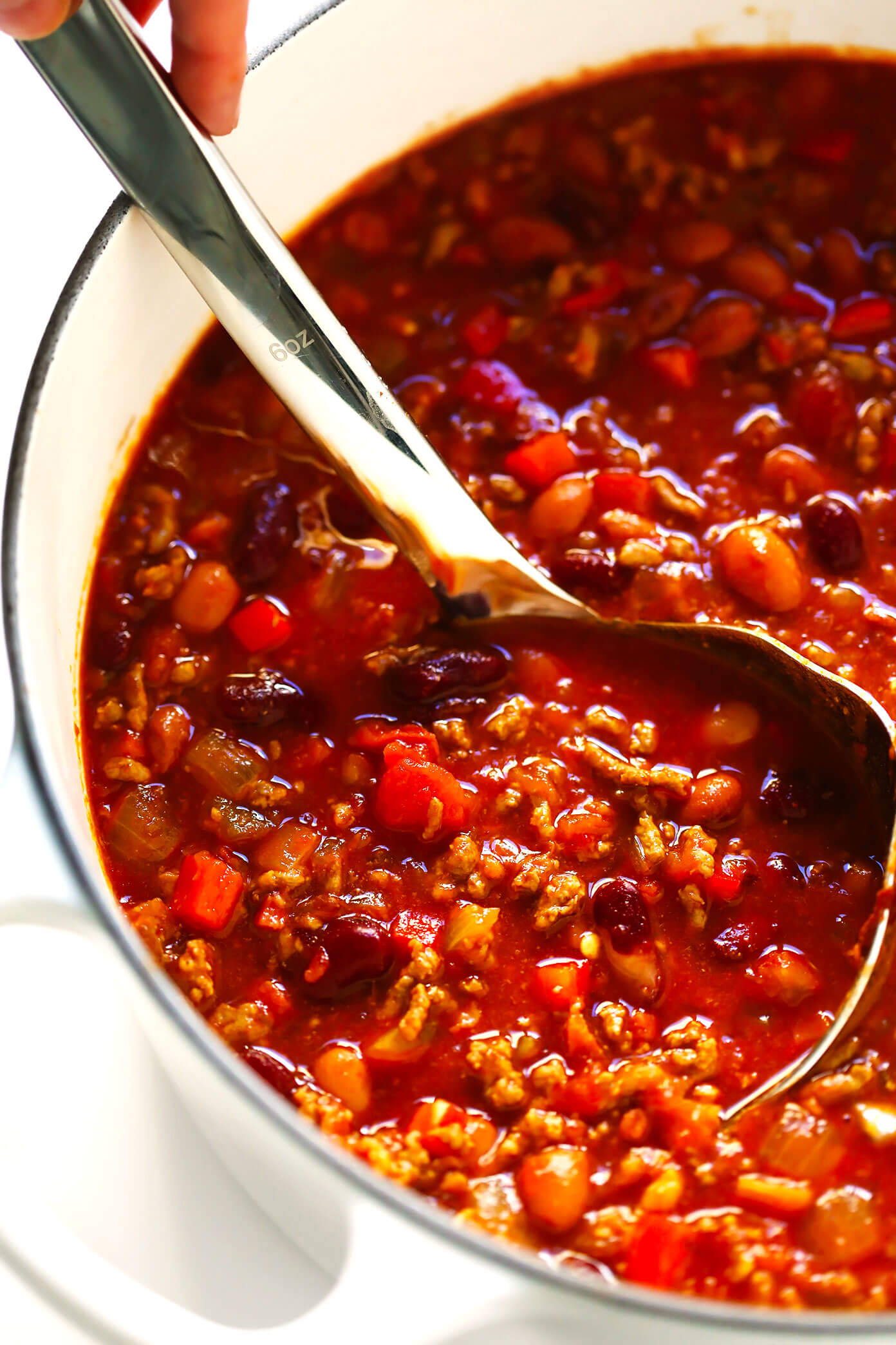 The BEST chili recipe -- made with beef, beans, veggies and the most deliciously seasoned tomato soup broth. Easy to make on the stovetop or in the Instant Pot (pressure cooker) or Crockpot (slow cooker), and always a crowd fave!! | gimmesomeoven.com #chili #soup #stew #dinner #football #mealprep #freezermeal #beef #glutenfree Beef Chili Recipe