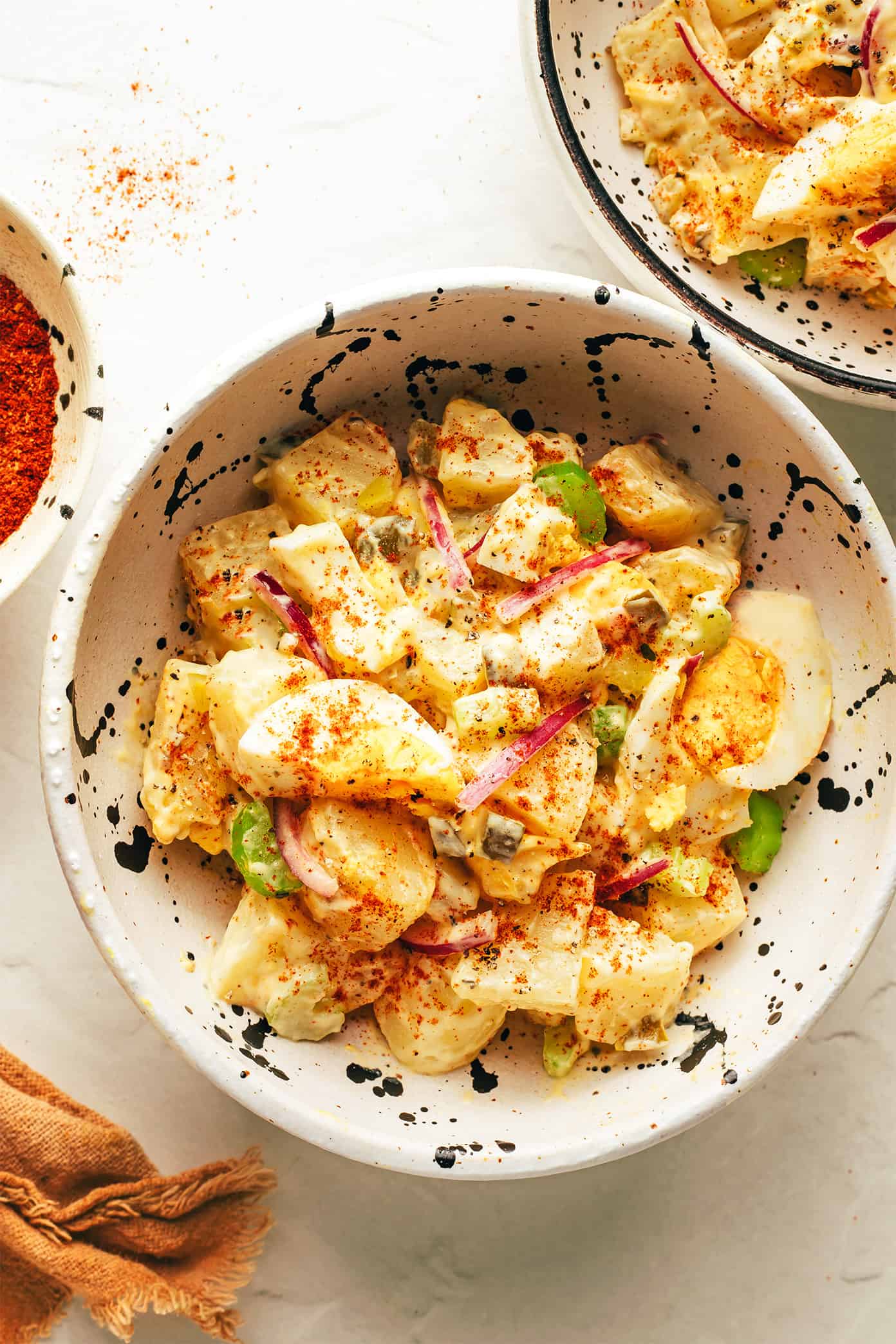 My go-to classic potato salad recipe is easy to make with tender potatoes, hard-boiled eggs, crisp veggies, pickle relish, and a zesty creamy dressing. It's the perfect make ahead side dish for potlucks, picnics and barbecues. And feel free to add some extra bacon or cheese if you'd like! | gimmesomeoven.com The best potato salad in a small serving bowl