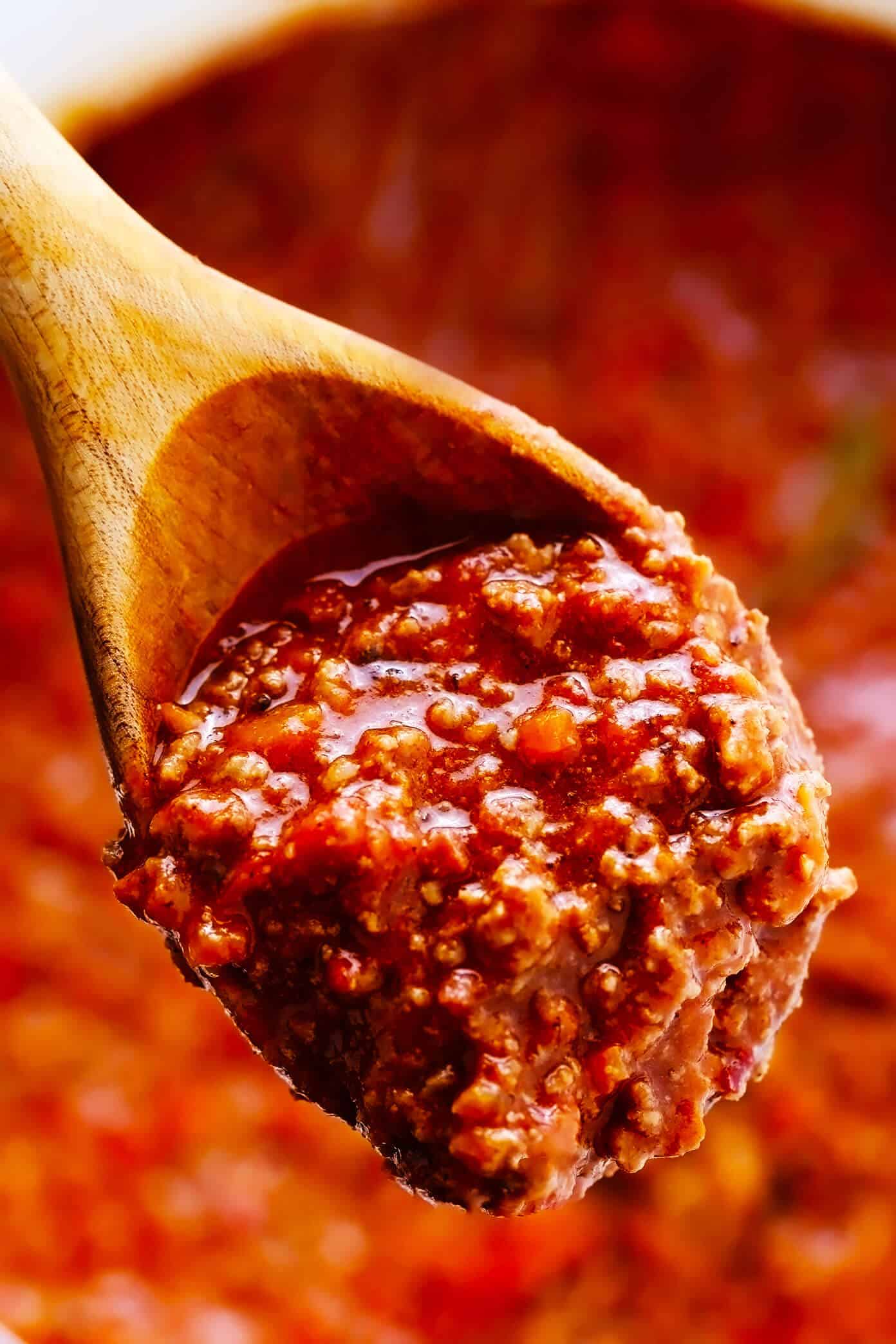 This amazing Bolognese sauce recipe is slow-simmered with a rich tomato base, a delicious blend of beef and pork, and the coziest blend of garlicky herb seasonings. Serve with pasta, gnocchi, or roasted eggplant and enjoy! | gimmesomeoven.com #bolognese #italian #meat #sauce #marinara #pasta #spaghetti #dinner #beef Closeup of Bolognese Sauce Recipe
