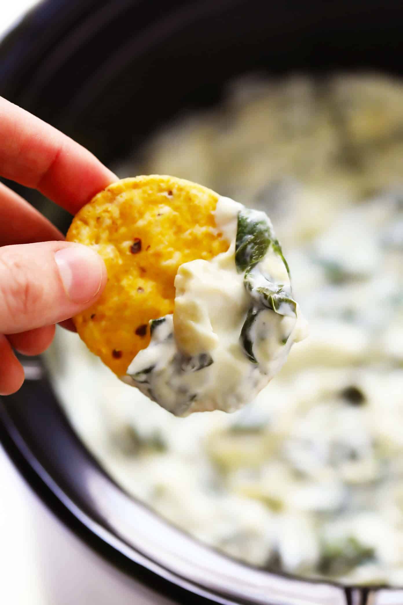 This Slow Cooker Spinach Artichoke Dip recipe is rich and creamy, full of great flavor, and extra-easy to make in the crockpot! The perfect easy appetizer or game day snack. | gimmesomeoven.com #dip #appetizer #spinach #artichoke #vegetarian #glutenfree #entertaining #holiday #gameday Easy Spinach Artichoke Dip Recipe