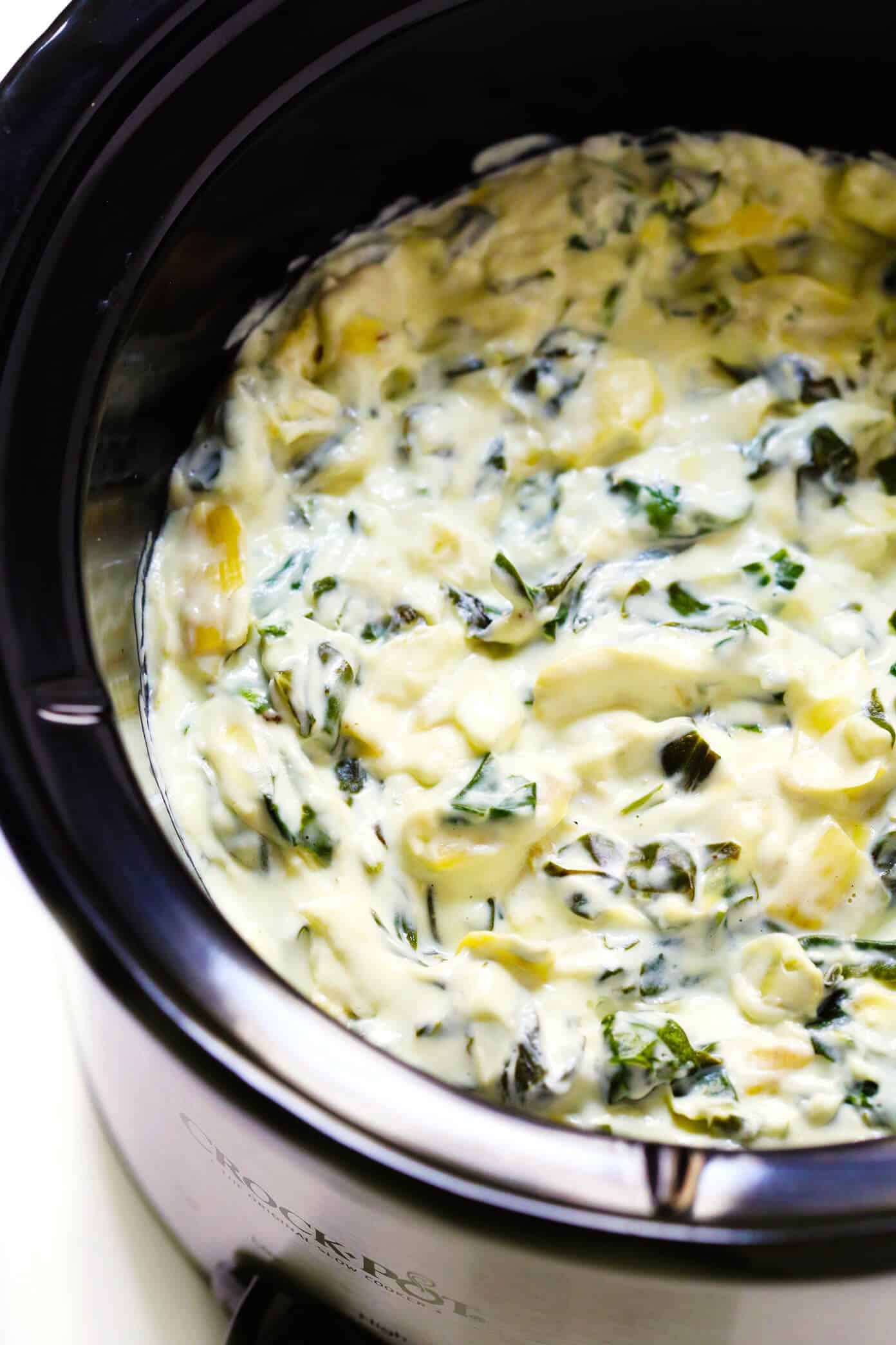 This Slow Cooker Spinach Artichoke Dip recipe is rich and creamy, full of great flavor, and extra-easy to make in the crockpot! The perfect easy appetizer or game day snack. | gimmesomeoven.com #dip #appetizer #spinach #artichoke #vegetarian #glutenfree #entertaining #holiday #gameday Hot Spinach Artichoke Dip Recipe