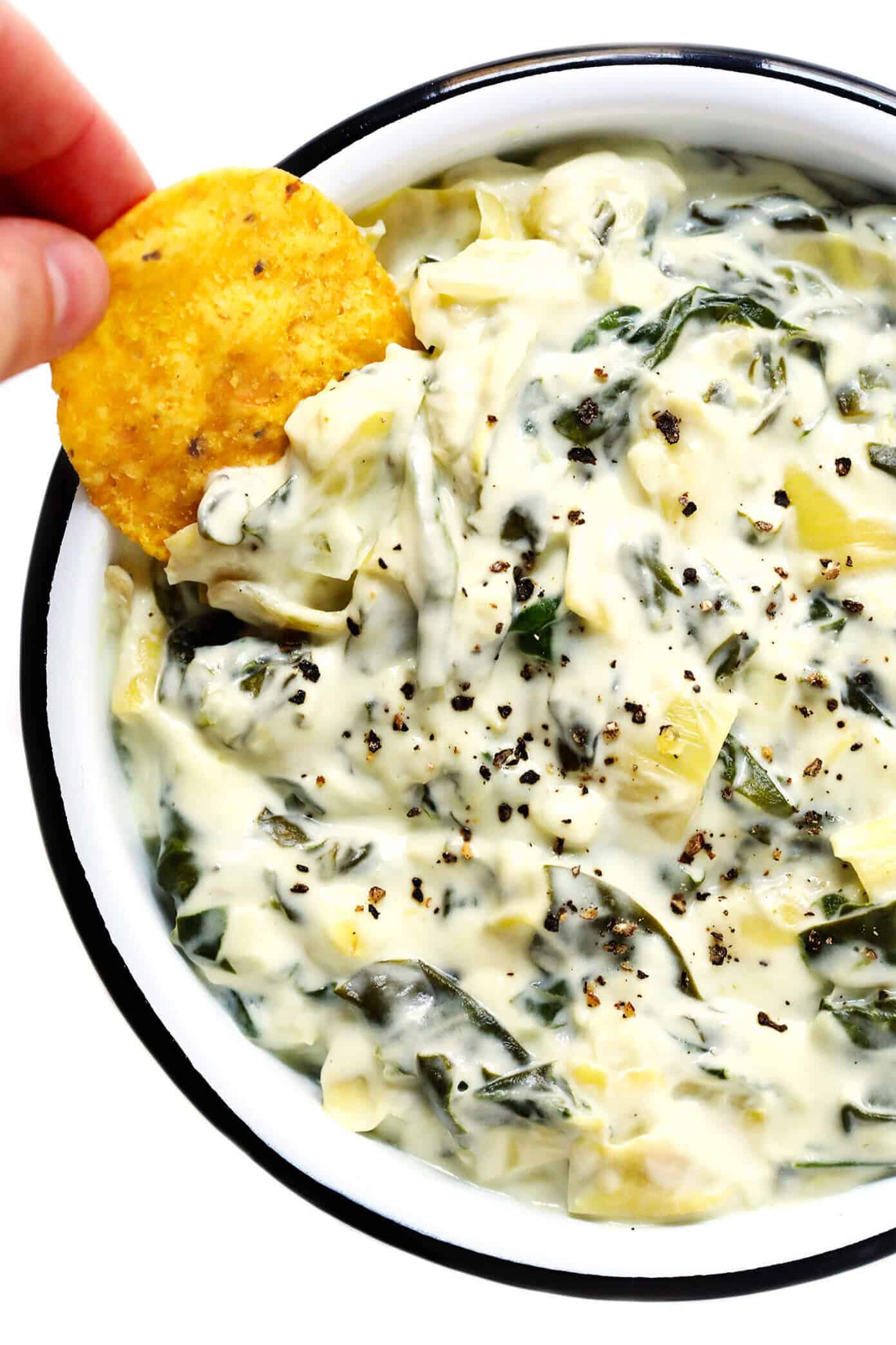 This Slow Cooker Spinach Artichoke Dip recipe is rich and creamy, full of great flavor, and extra-easy to make in the crockpot! The perfect easy appetizer or game day snack. | gimmesomeoven.com #dip #appetizer #spinach #artichoke #vegetarian #glutenfree #entertaining #holiday #gameday Spinach and Artichoke Dip Recipe