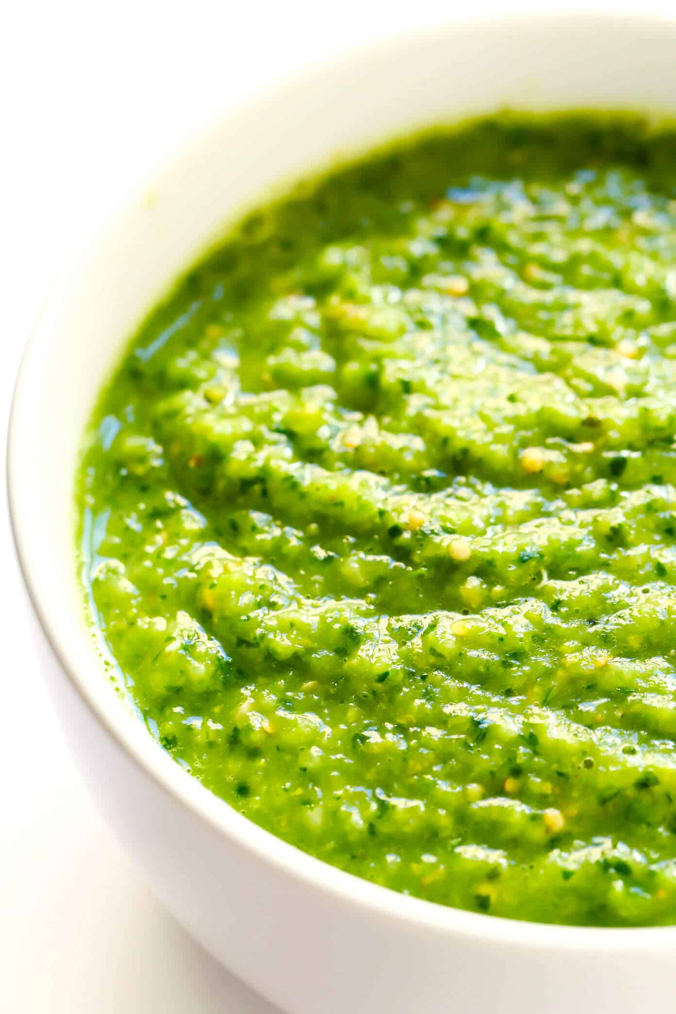 This fresh ("cruda") salsa verde recipe is easy to make in 5 minutes with raw tomatillos and avocado, and tastes refreshingly sweet, light and delicious! Serve with tortilla chips or fries, drizzle on burgers or kabobs, or whatever sounds good! | gimmesomeoven.com #salsa #verde #tomatillo #mexican #raw #glutenfree #vegan #vegetarian #healthy #sauce Salsa Verde Cruda in a bowl