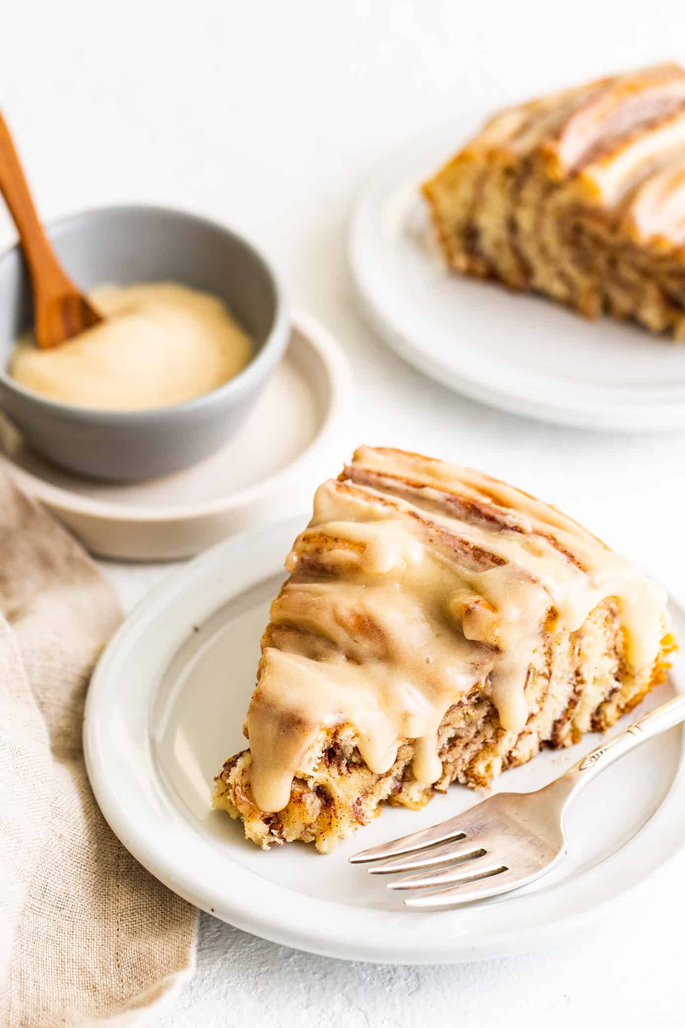 This giant cinnamon roll recipe is made with the most delicious soft dough, cinnamon-sugar filling, and a tangy cream cheese icing. Ready to go for breakfast or brunch in one hour from start to finish! | gimmesomeoven.com Giant Cinnamon Roll Slices with Cream Cheese Frosting