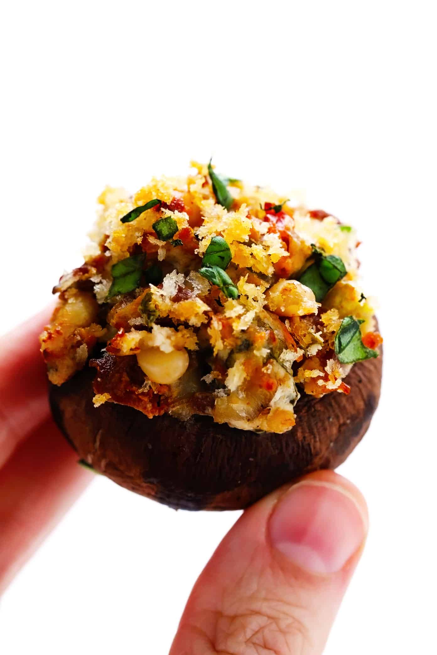 This easy stuffed mushrooms recipe is made with a garlicky goat cheese, sun-dried tomato, pine nut and basil filling and topped with crispy toasted breadcrumbs. The perfect vegetarian appetizer that's easy to make ahead of time (up to 1 day in advance) and always a crowd fave! | gimmesomeoven.com Individual Stuffed Mushroom with Goat Cheese and Sun-Dried Tomatoes