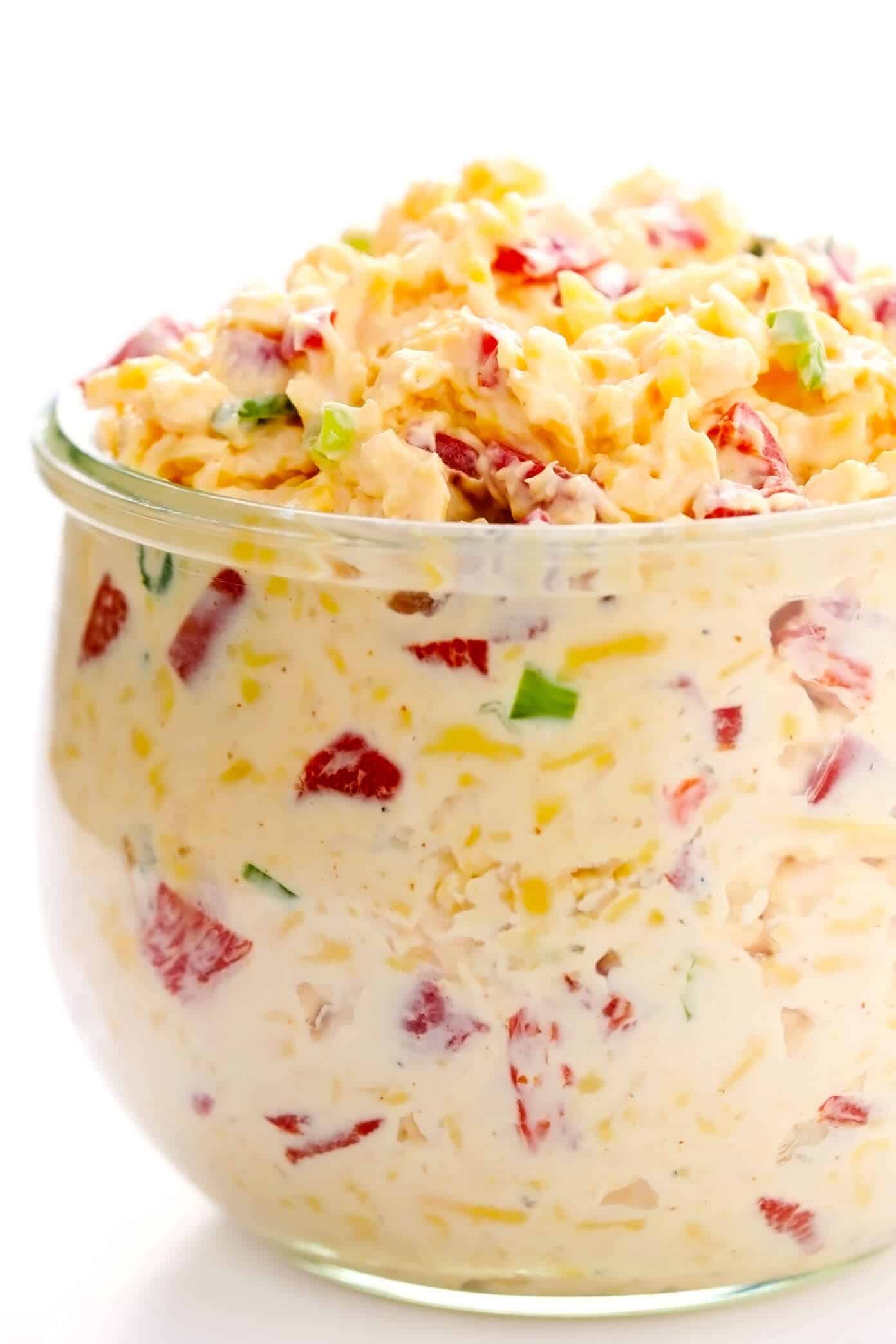 This 10-minute homemade pimento cheese recipe is made with sharp cheddar, tangy cream cheese and mayo, roasted red peppers, fresh green onions, and a zesty blend of seasonings. Serve it as a appetizer dip or spread on sandwiches, burgers, veggies, or whatever sounds good. | gimmesomeoven.com #pimento #pepper #cheese #dip #spread #glutenfree #southern #sandwich Homemade Pimento Cheese Spread in Jar
