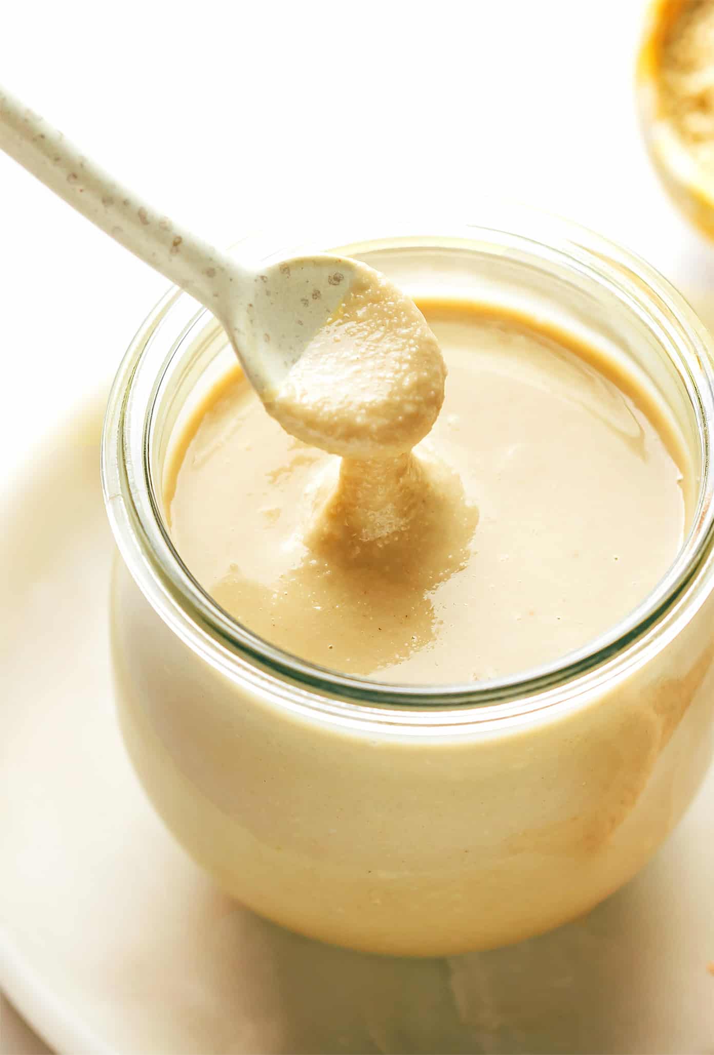 This homemade tahini recipe is easy to make with 3 ingredients and tastes so deliciously nutty and creamy. Use this Middle Eastern condiment to make dips like hummus or baba ganoush, or add it to everything from salad dressings to smoothies, baked goods and more. Naturally gluten-free, vegetarian and vegan. | gimmesomeoven.com Homemade Tahini in Jar