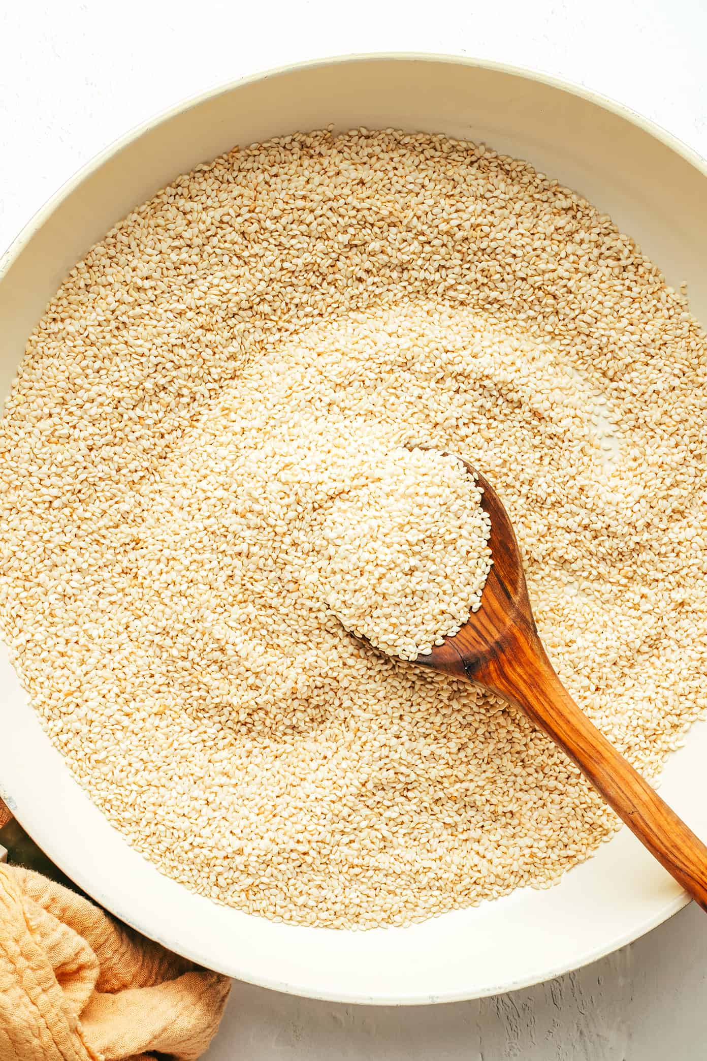 This homemade tahini recipe is easy to make with 3 ingredients and tastes so deliciously nutty and creamy. Use this Middle Eastern condiment to make dips like hummus or baba ganoush, or add it to everything from salad dressings to smoothies, baked goods and more. Naturally gluten-free, vegetarian and vegan. | gimmesomeoven.com Toasting sesame seeds to make homemade tahini