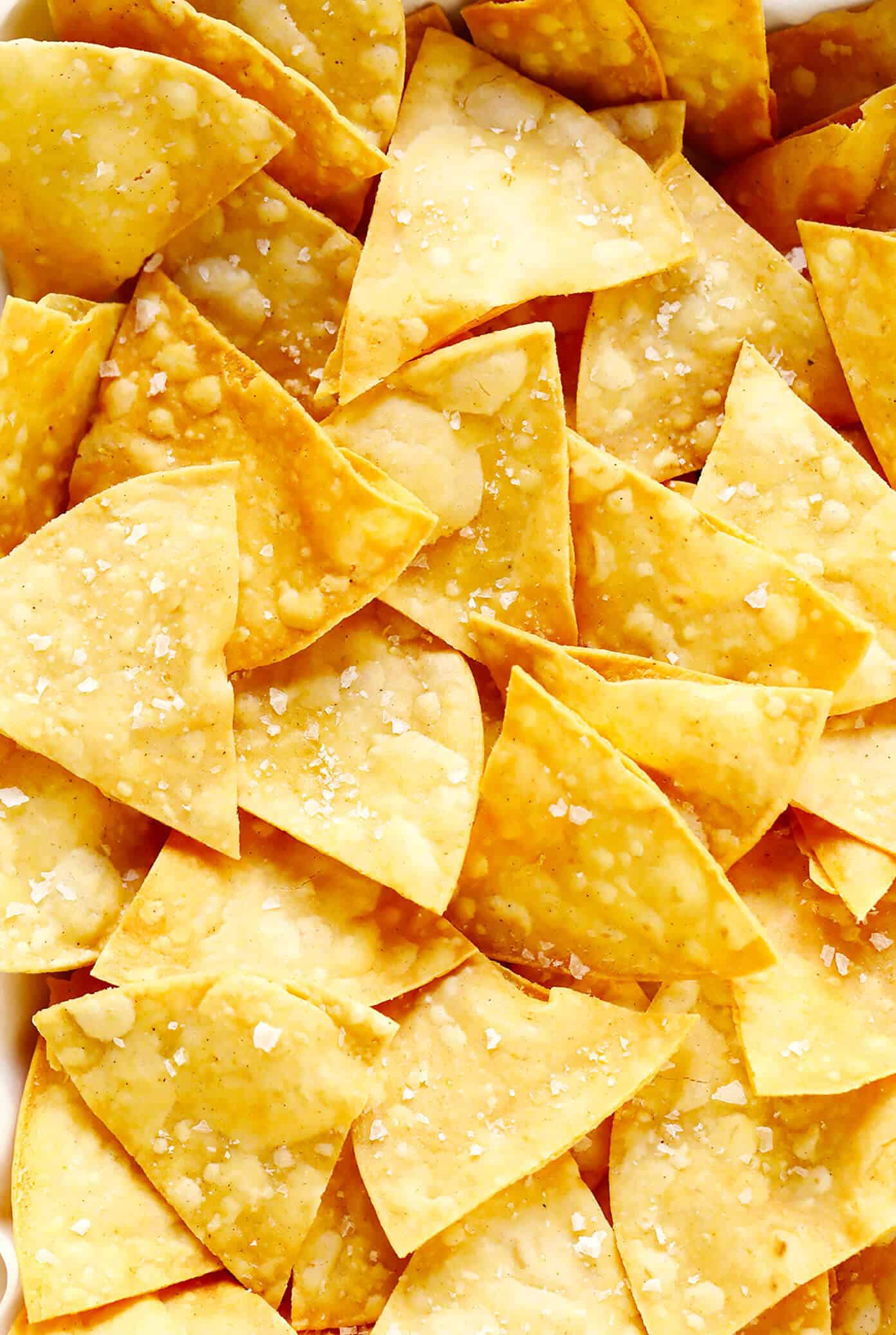 This homemade tortilla chips recipe is easy to make with 3 basic ingredients (corn tortillas, oil and salt) and always SO delicious! | gimmesomeoven.com #homemade #corn #tortilla #chips #glutenfree #vegan #vegetarian #appetizer #gameday #snack Homemade Tortilla Chips
