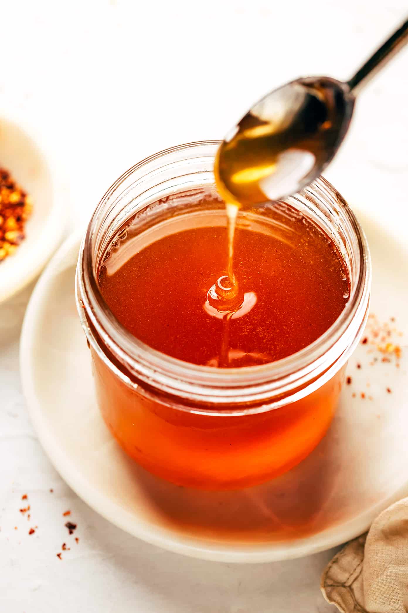 This homemade hot honey recipe is quick and easy to make with 3 ingredients and tastes delicious drizzled on everything from pizza to biscuits, fried chicken, salmon, veggies, baked brie and more! | gimmesomeoven.com Hot Honey