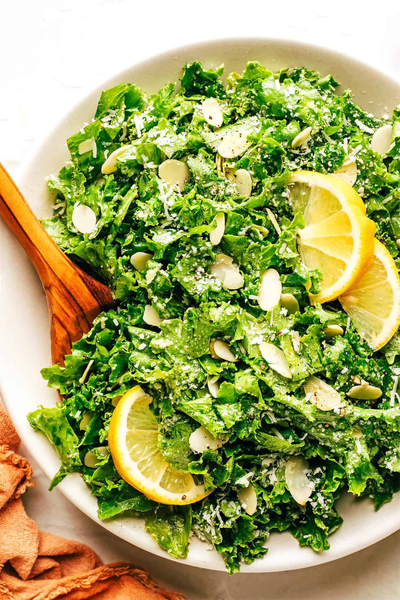 This easy kale salad recipe only takes 5 minutes to make with kale, Parmesan, sliced almonds, lemon, olive oil, and tastes great with just about everything! Feel free to add extra veggies or a protein (such as chicken, shrimp, salmon, etc) if you'd like. | gimmesomeoven.com Easy Kale Salad