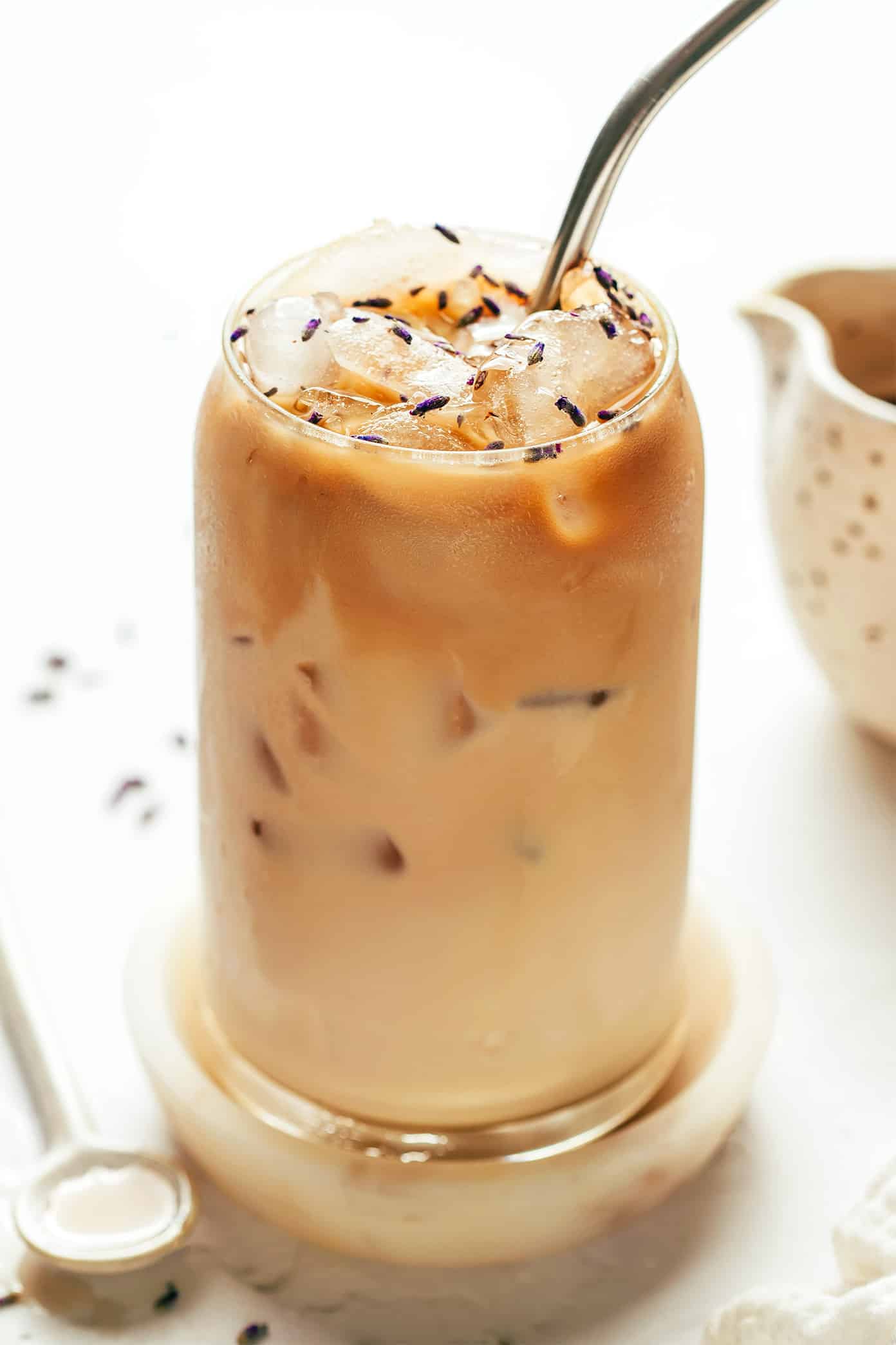 This homemade lavender latte recipe can be made hot or iced and is easy to customize with your favorite milk, espresso and add-ins. So delicious and less expensive than the coffee shop version! | gimmesomeoven.com Iced Lavender Latte
