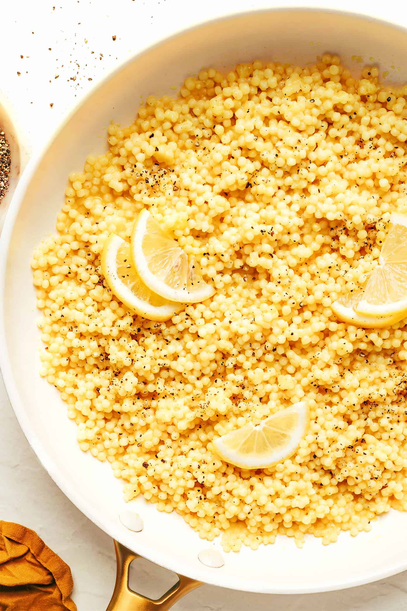 This lemon Parmesan pearl couscous recipe is a simple, versatile, and delicious side dish that pairs beautifully with everything from roasted veggies to grilled meats and more. | gimmesomeoven.com Lemon Parmesan Pearl Couscous