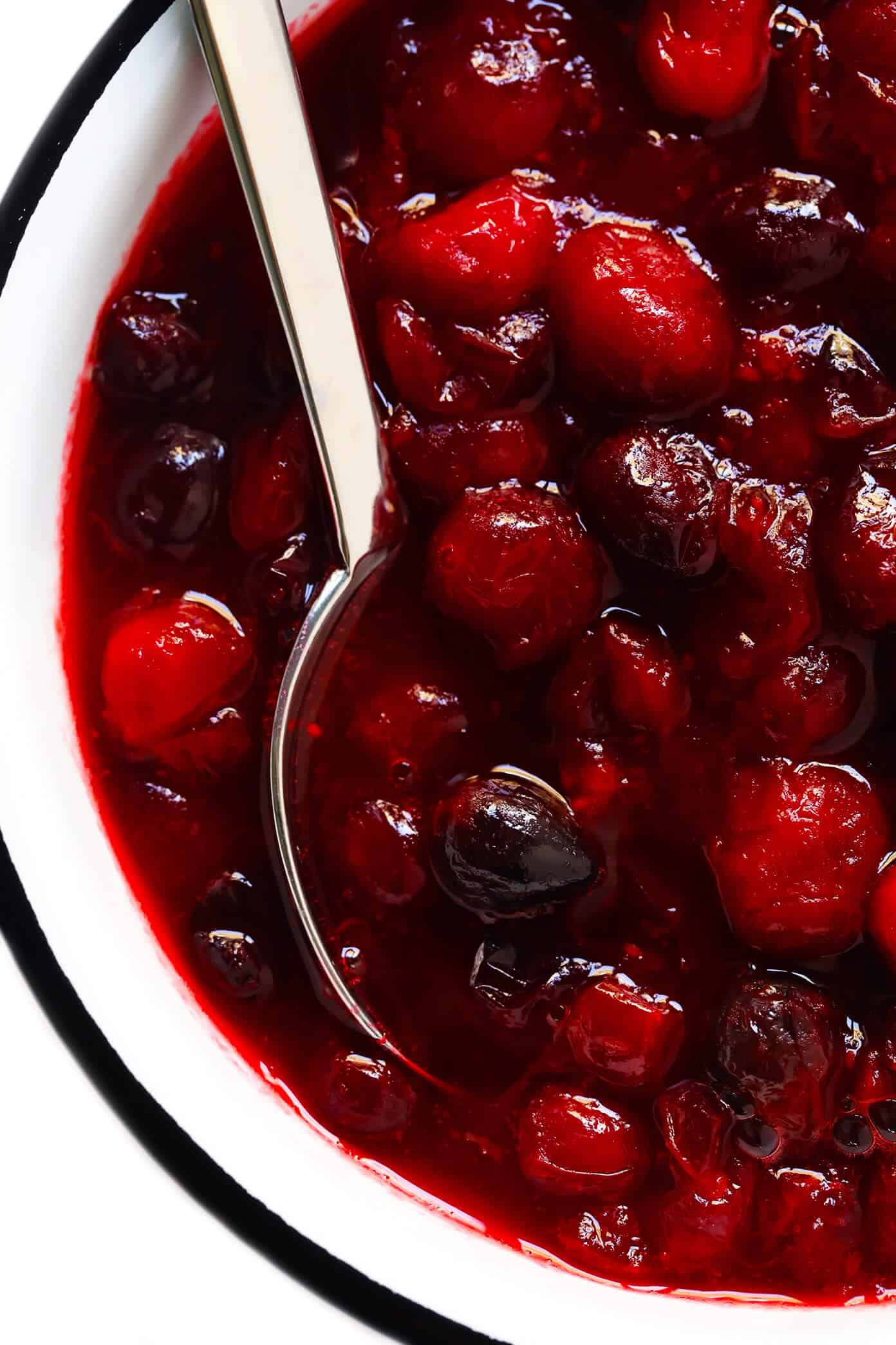 This homemade Maple Cranberry Sauce recipe is naturally-sweetened with real maple syrup, it's easy to make in about 15 minutes, and it's totally delicious. Perfect for Thanksgiving, Christmas, or anytime you'd love an extra pop of color on the dinner table. | Gimme Some Oven #cranberry #sauce #thanksgiving #naturallysweetened #sugarfree #maple #vegan #glutenfree #vegetarian #side #christmas #holiday #dinner Homemade Cranberry Sauce in Bowl