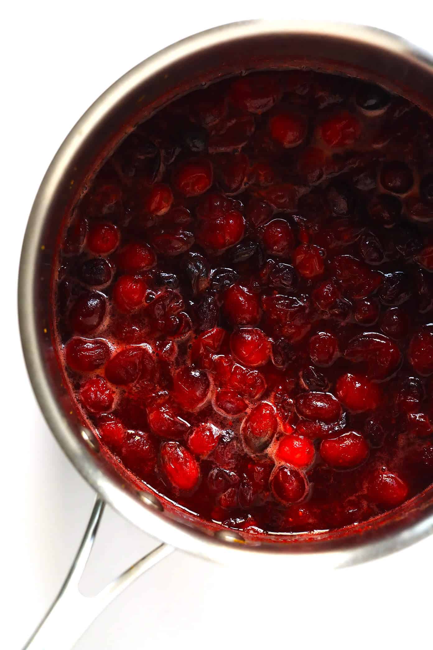 This homemade Maple Cranberry Sauce recipe is naturally-sweetened with real maple syrup, it's easy to make in about 15 minutes, and it's totally delicious. Perfect for Thanksgiving, Christmas, or anytime you'd love an extra pop of color on the dinner table. | Gimme Some Oven #cranberry #sauce #thanksgiving #naturallysweetened #sugarfree #maple #vegan #glutenfree #vegetarian #side #christmas #holiday #dinner Cranberry Sauce in Saucepan