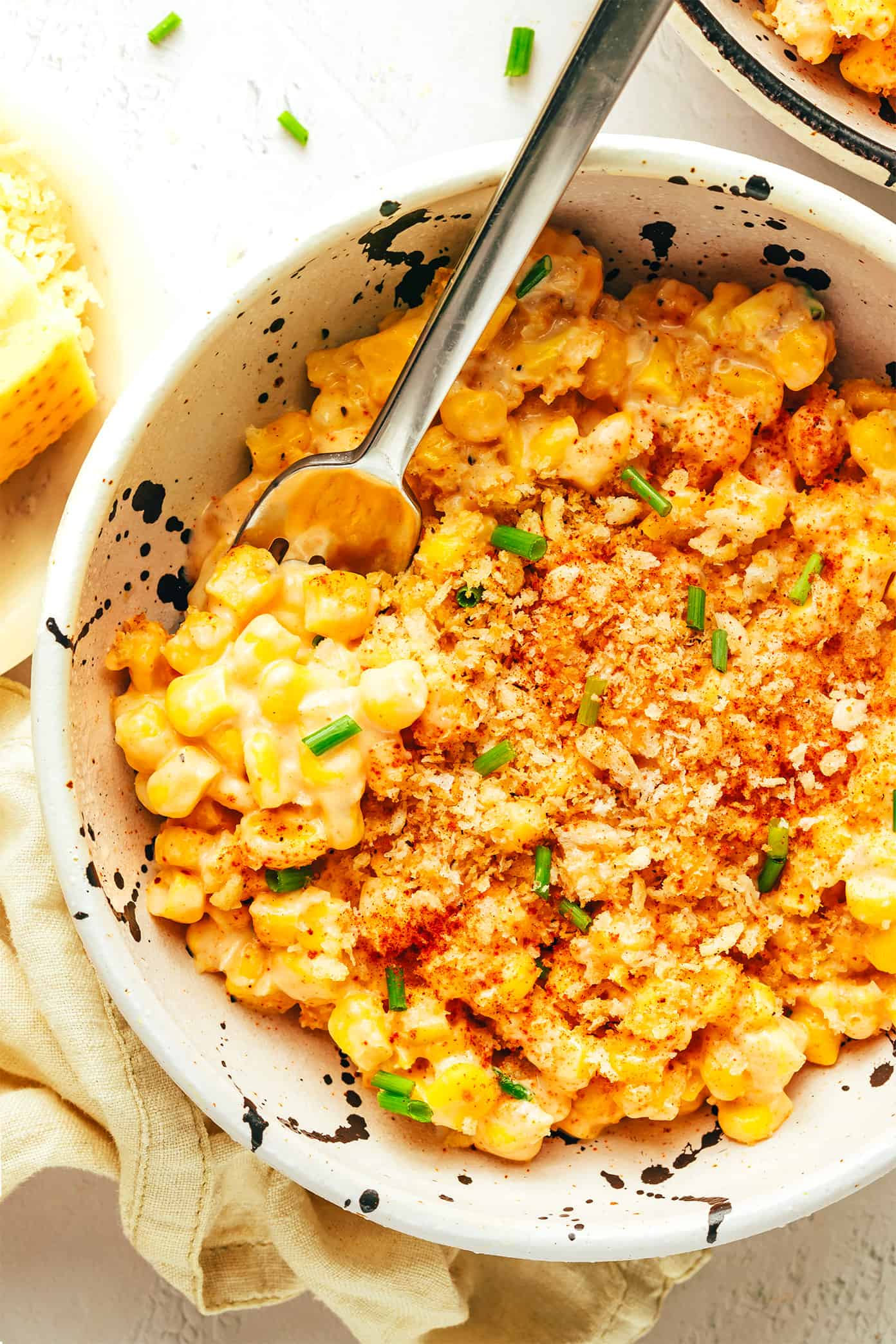 This Parmesan Creamed Corn recipe is layered with sweet and savory flavors, perfectly creamy and cheesy, and sprinkled with irresistible crispy toasted garlic breadcrumbs. Perfect for the holidays, such as Thanksgiving or Christmas, or for any weeknight dinner that needs a simple side dish! | gimmesomeoven.com Parmesan Creamed Corn