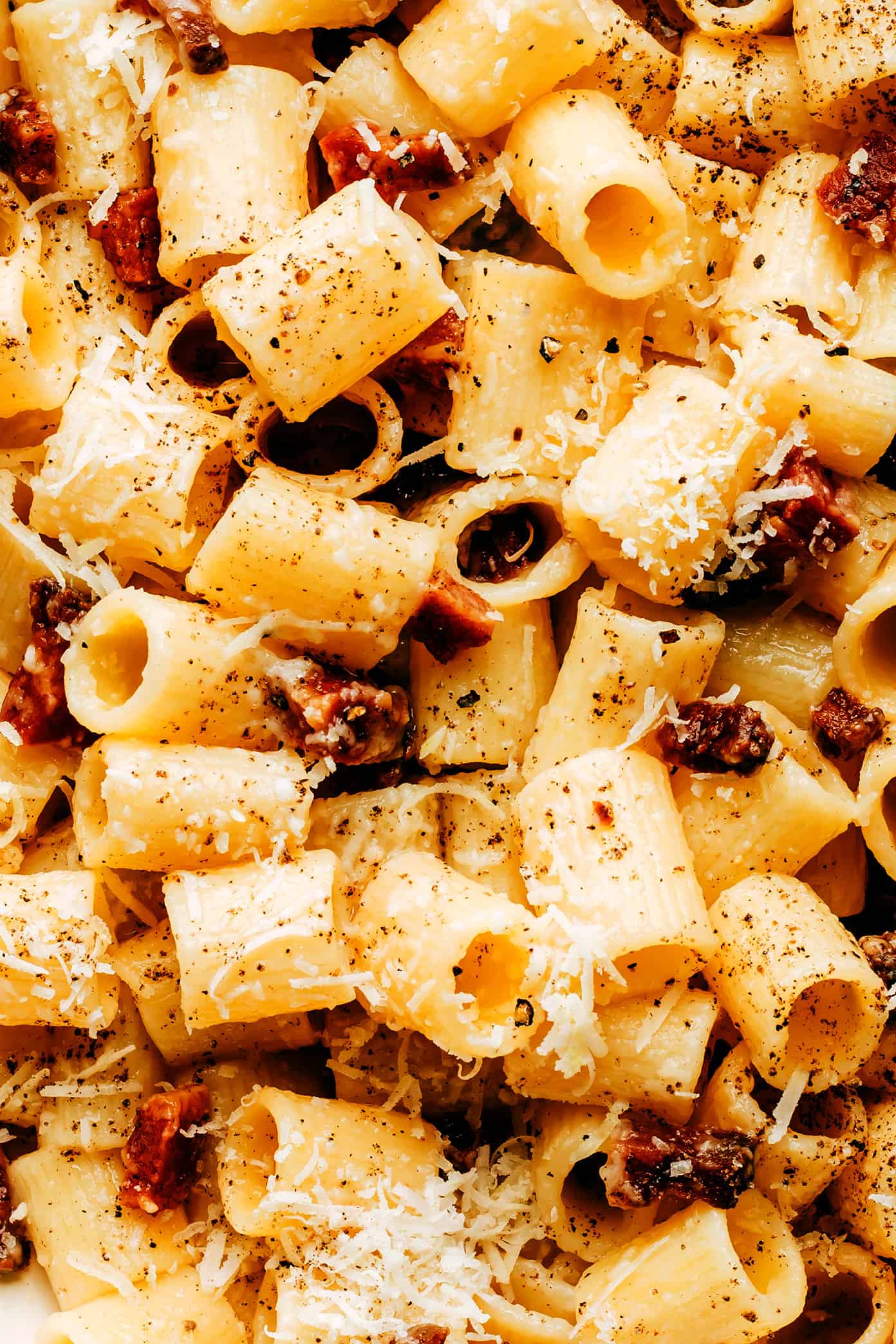 This classic Roman pasta alla gricia recipe is easy to make with 3 ingredients -- bacon (guanciale), cheese (Pecorino) and pasta (rigatoni or spaghetti) and always tastes SO decadent and flavorful. The perfect easy dinner for Italian night! | gimmesomeoven.com Pasta alla Gricia closeup