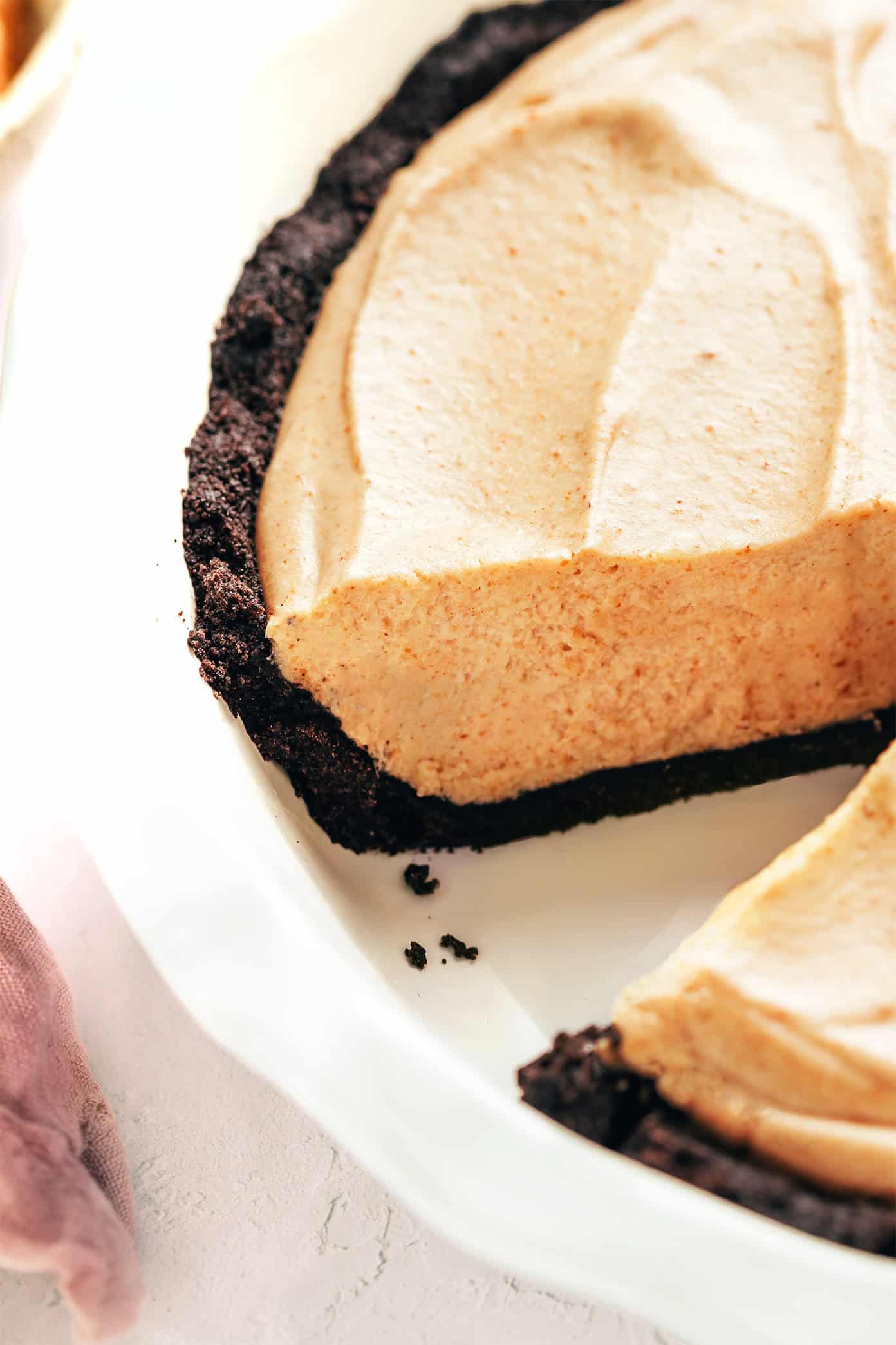 This classic no-bake peanut butter pie recipe features a chocolate Oreo crust and a fluffy peanut butter filling. The perfect easy summer dessert! | gimmesomeoven.com Peanut Butter Pie with slice removed