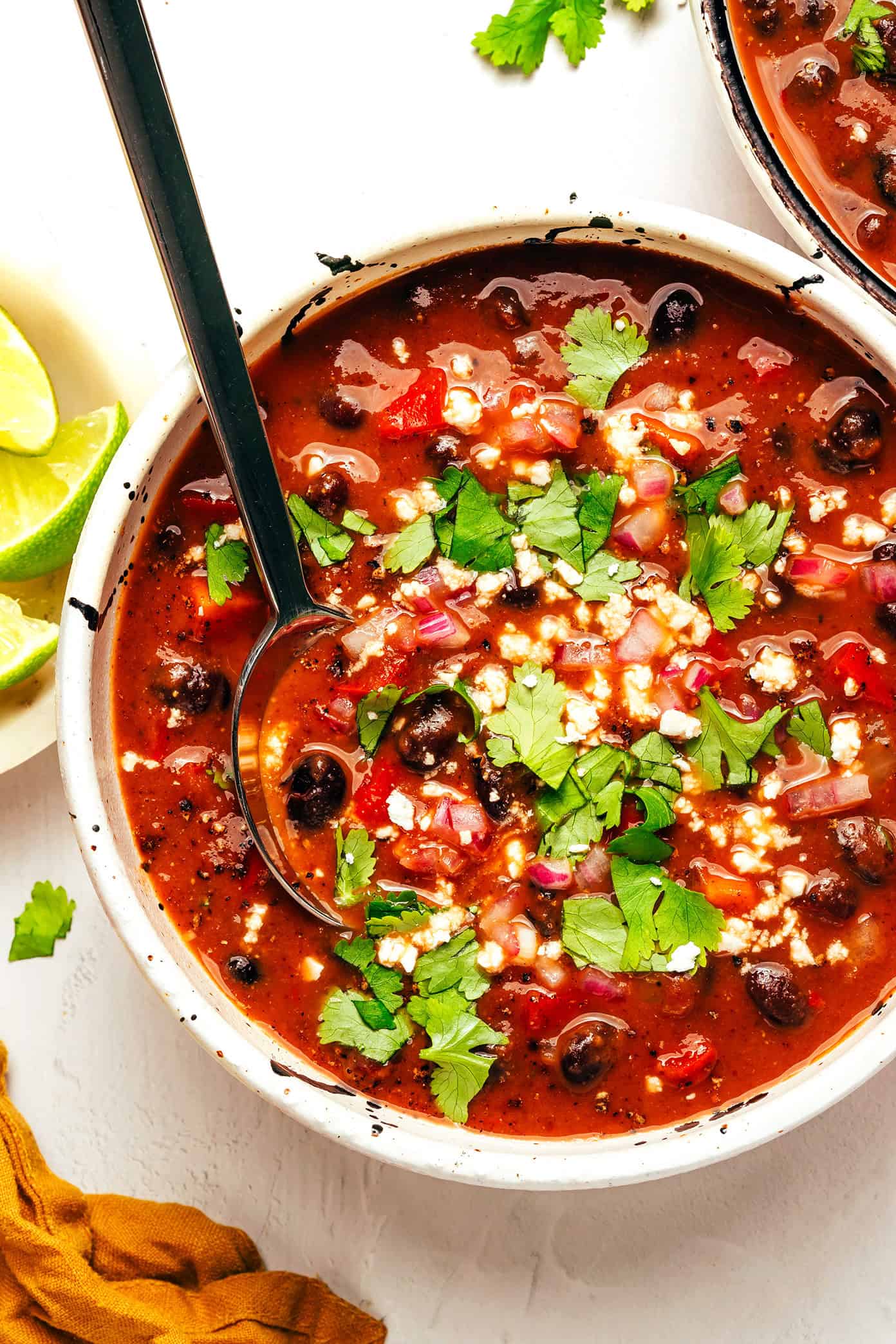 This Mexican-inspired quick black bean soup recipe is full of flavor and protein and comes together in less than 30 minutes! A delicious, feel-good dinner that's naturally gluten-free, vegetarian and vegan. | gimmesomeoven.com Vegetarian Black Bean Soup with Cilantro