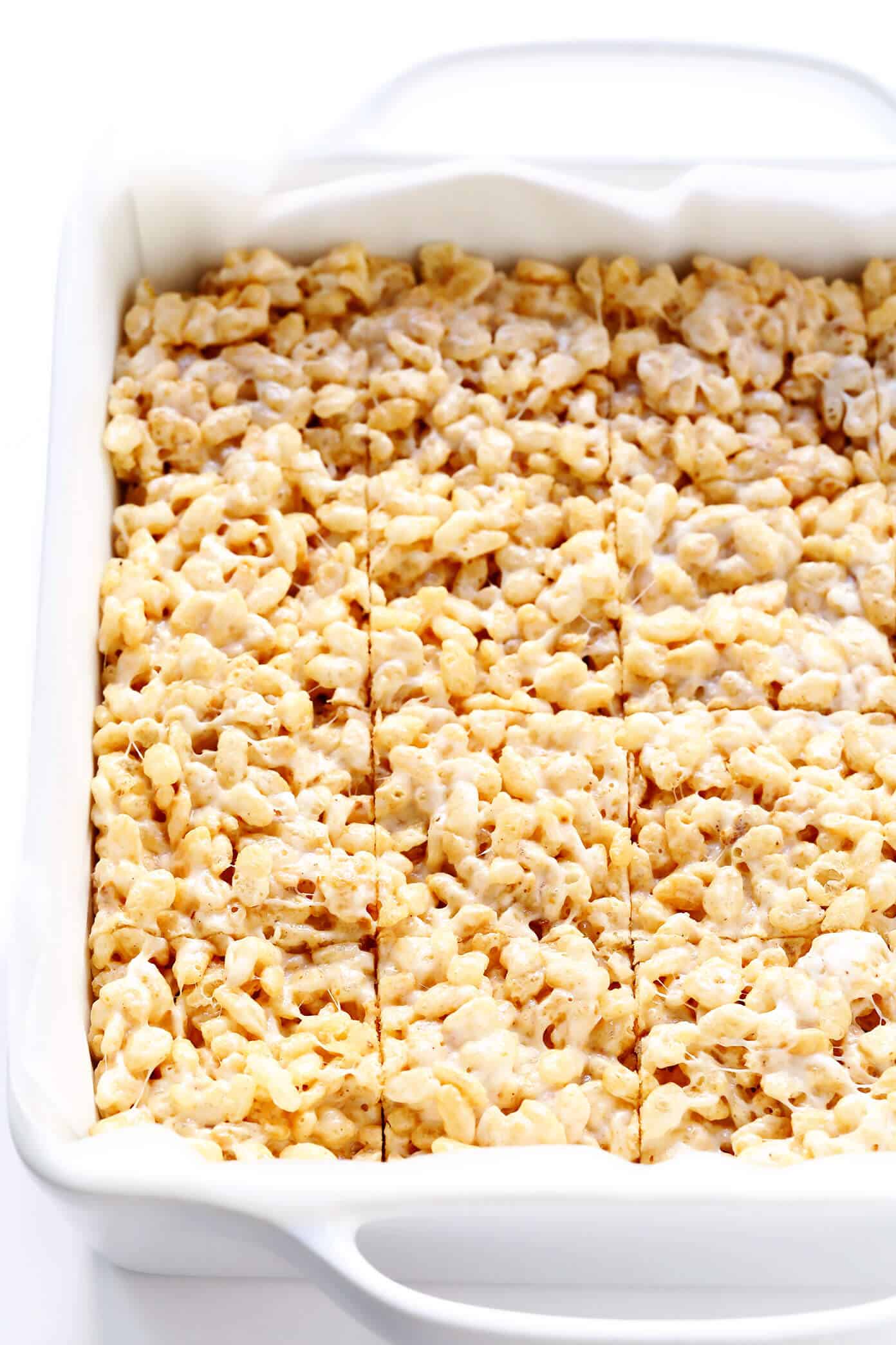 The classic 3-ingredient Rice Krispie Treats recipe is kicked up an irresistible notch with brown butter, toasted marshmallows, a splash of bourbon (if you'd like), and an extra pinch of sea salt. Always a delicious and nostalgic easy dessert recipe! | gimmesomeoven.com #ricekrispies #treats #cereal #dessert #vegan #treat #marshmallow Rice Krispie Treats Bars In Baking Dish
