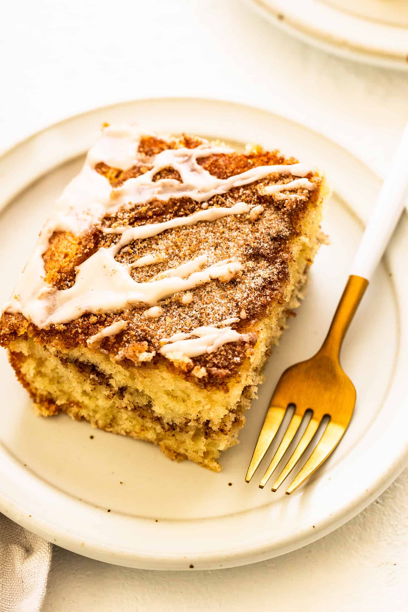 My favorite sour cream coffee cake recipe is perfectly soft and fluffy, layered with cinnamon sugar, and always so delicious. It's the perfect sweet treat for breakfast, snack or dessert, and always so nostalgic and comforting. | gimmesomeoven.com Sour Cream Coffee Cake with Fork