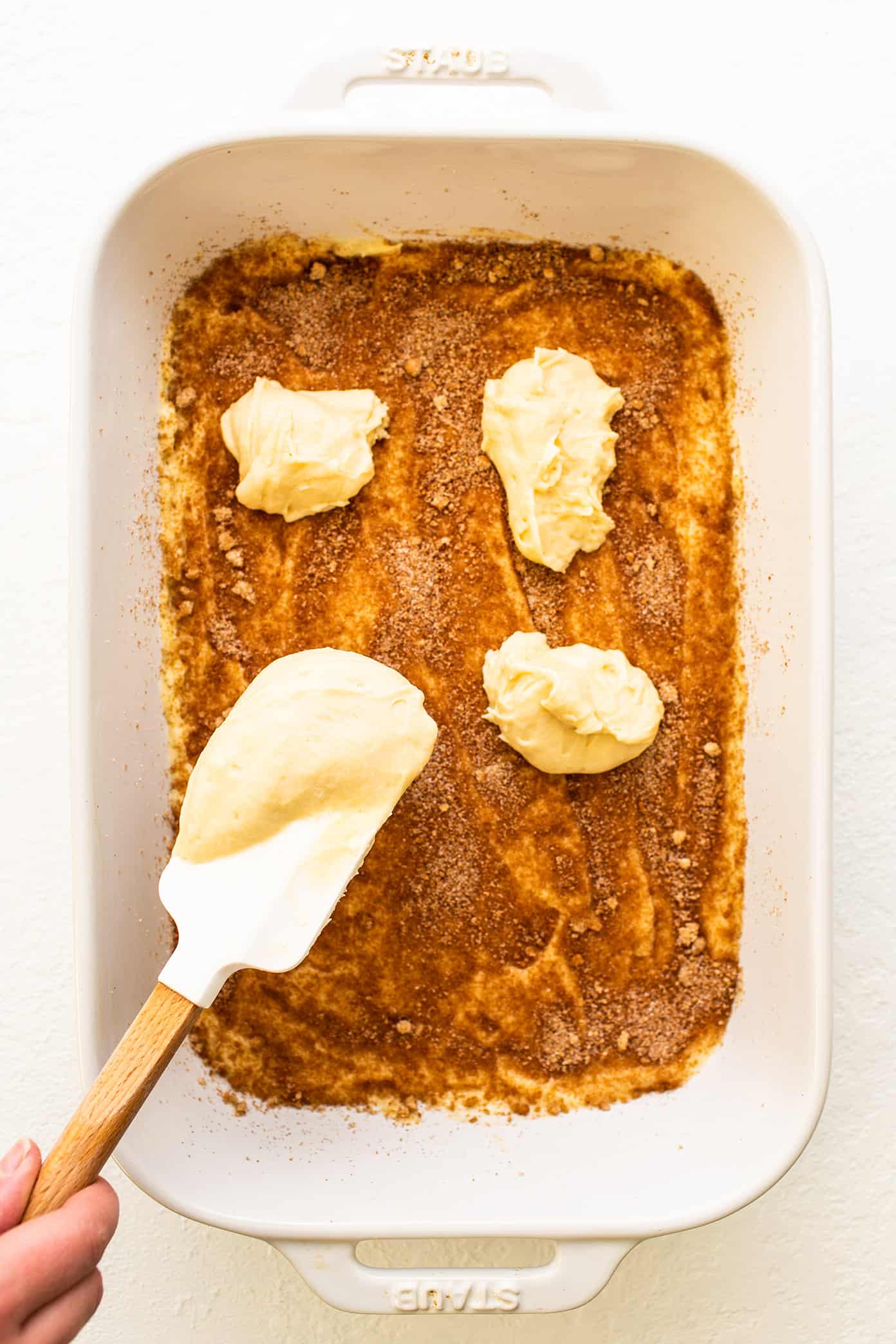 My favorite sour cream coffee cake recipe is perfectly soft and fluffy, layered with cinnamon sugar, and always so delicious. It's the perfect sweet treat for breakfast, snack or dessert, and always so nostalgic and comforting. | gimmesomeoven.com Layering the batter to make homemade coffee cake