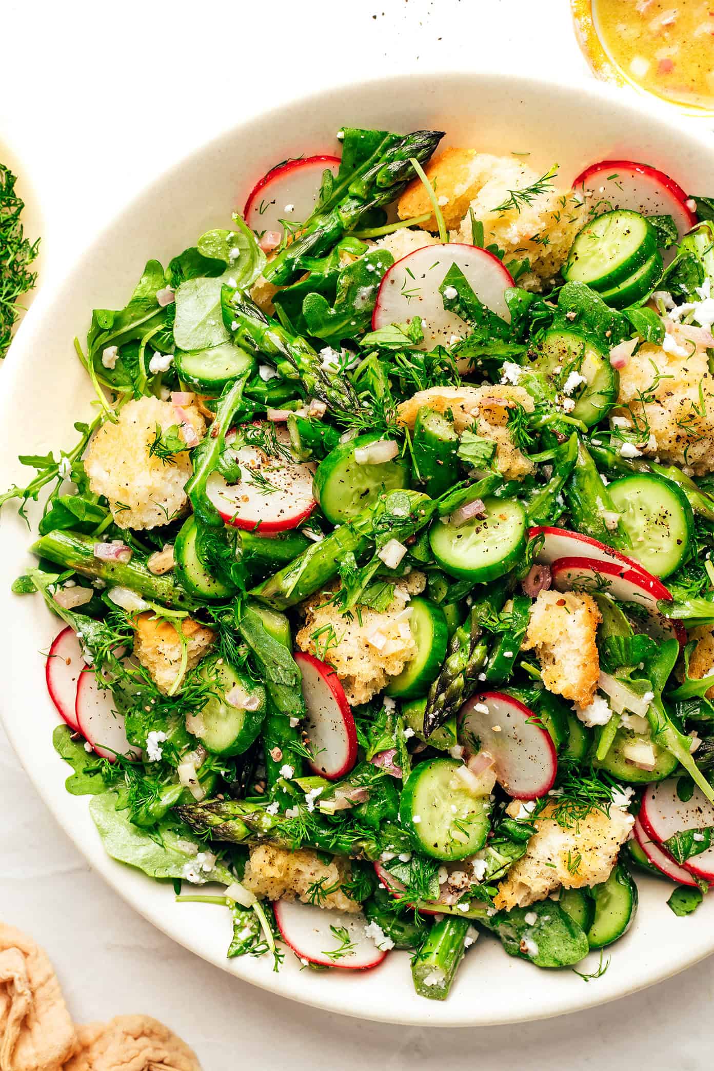 This vibrant spring panzanella salad recipe features crispy sourdough croutons, roasted asparagus, fresh veggies, herbs, feta, and a lemony shallot vinaigrette. | gimmesomeoven.com Spring Panzanella with Sourdough Croutons
