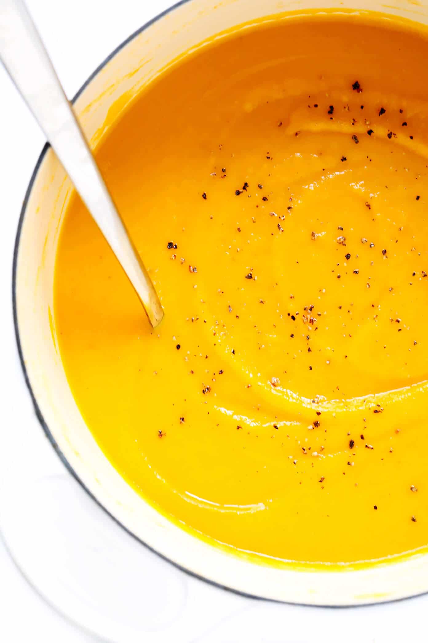 This delicious Butternut Squash Soup recipe is quick and easy to make, loaded up with savory fall vegetables, lightened up with coconut milk (no heavy cream needed), and SO cozy and delicious. Naturally gluten-free, vegetarian, vegan and easy to make in either the Instant Pot, Crock Pot, or on the stovetop. The perfect healthy comfort food dinner recipe for fall or winter! | gimmesomeoven.com Best Butternut Squash Soup recipe in dutch oven
