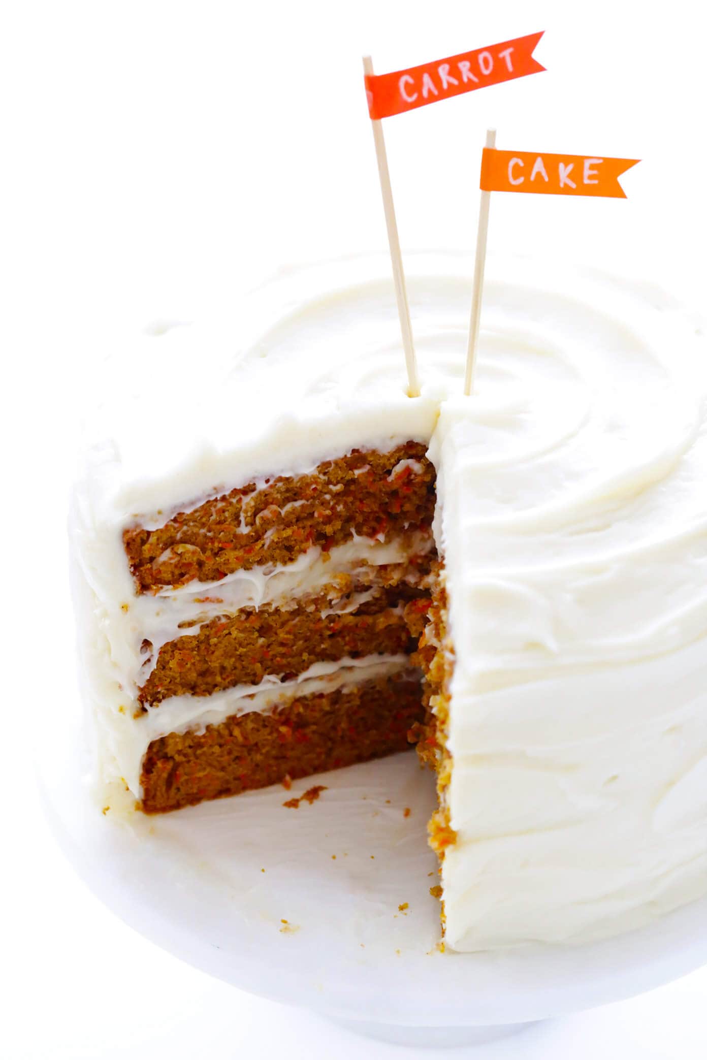 The BEST Carrot Cake Recipe! It's made with an easy homemade carrot cake (no mixer required) and the most heavenly cream cheese frosting. | gimmesomeoven.com #carrot #cake #dessert #easter #creamcheese #frosting #spring #vegetarian The BEST Carrot Cake Recipe